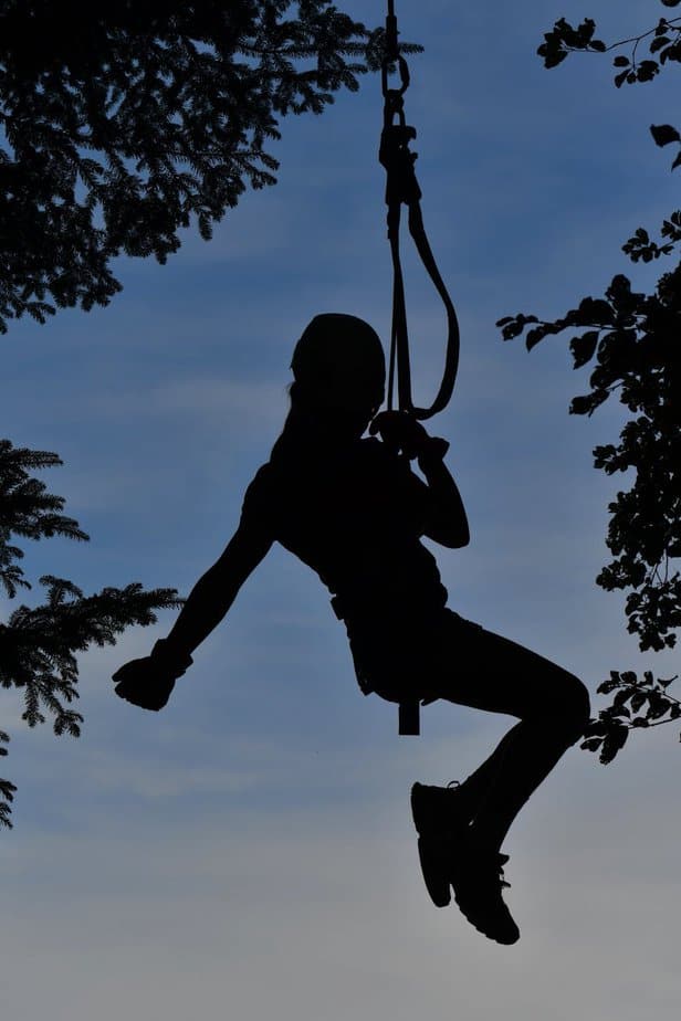 silhouette of person hanging in harness